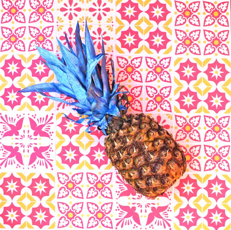 Blue pineapple in front of printable DIY talavera tiles