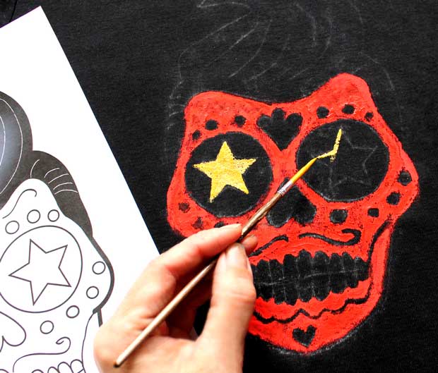 Paint a DIY Day of the Dead Calavera skull onto a T-shirt: Step 3 - Paint the stars with gold